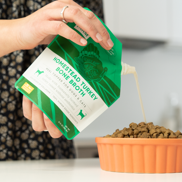 Homestead Turkey Bone Broth Bundle of 3 Pouches for Dogs, pouring on dog food, at Barking Dog Bakery and Feed
